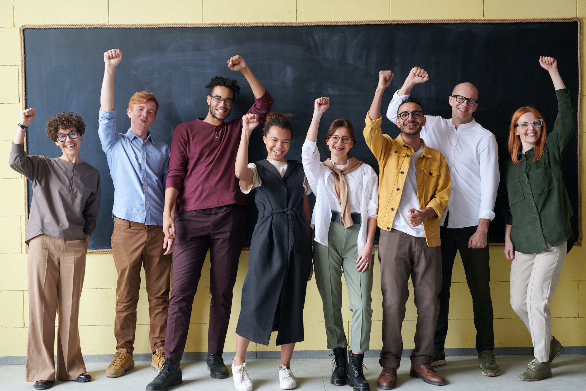 group of people standing infront of blackboard